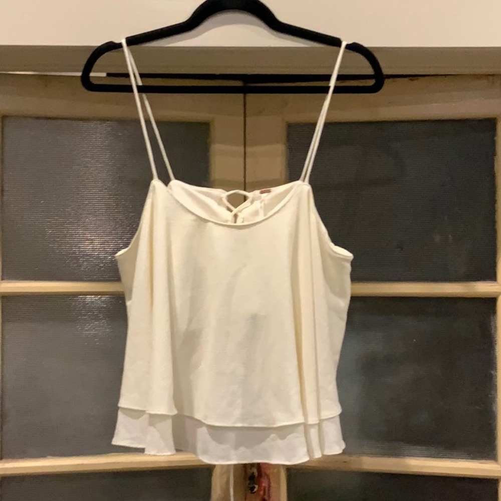 Adorable Free People flouncy top in creme. Large, lace back